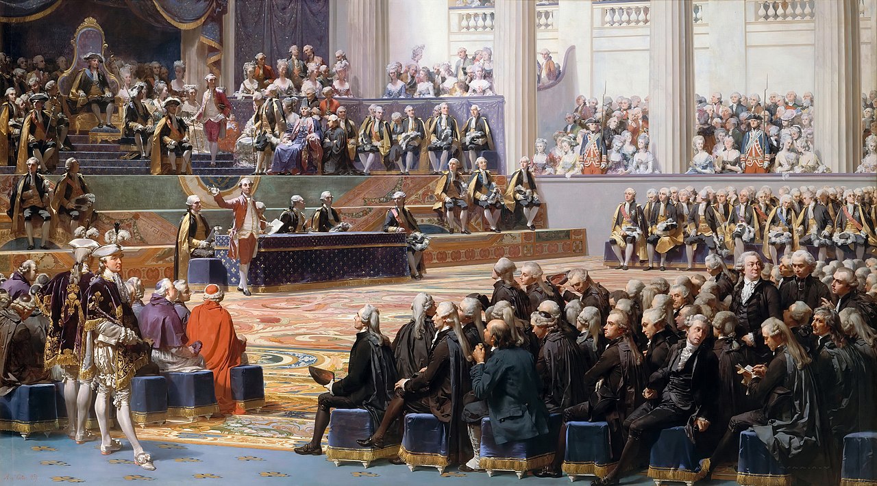 Sesión de apertura de los Estados generales de 1789, el 5 de mayo, en Versalles, según pintura de Auguste Couder. Preside Luis XVI y habla Necker. Se identifican muchos de los participantes.